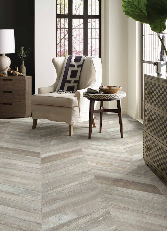 wood look tile flooring in a neutral living room with large windows